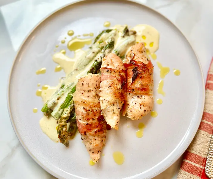 Filetitos de pollo envueltos en tocino crocante con espárragos cremosos