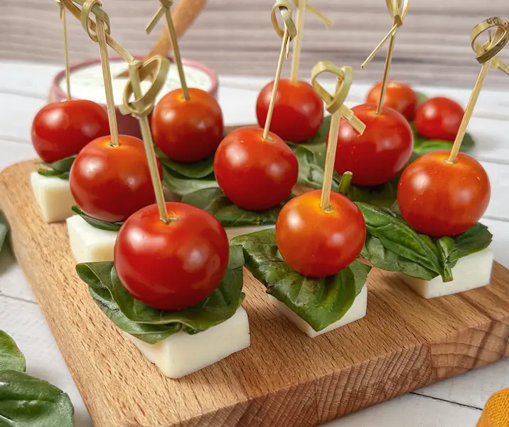 Brochetas de queso de cabra, tomates cherry y albahaca